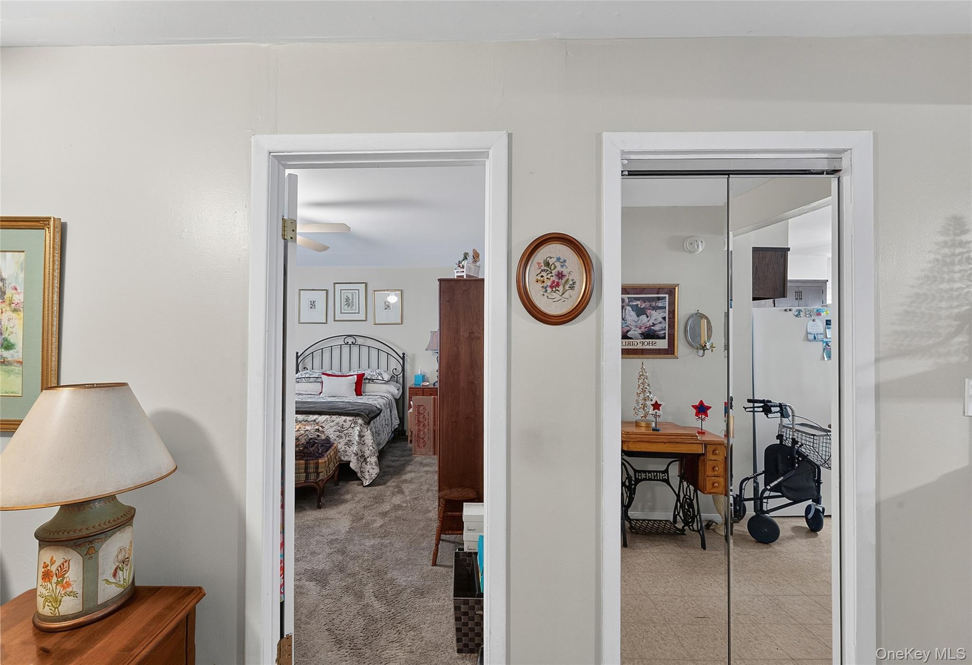 Interior doorway leading to a carpeted room with a ceiling fan