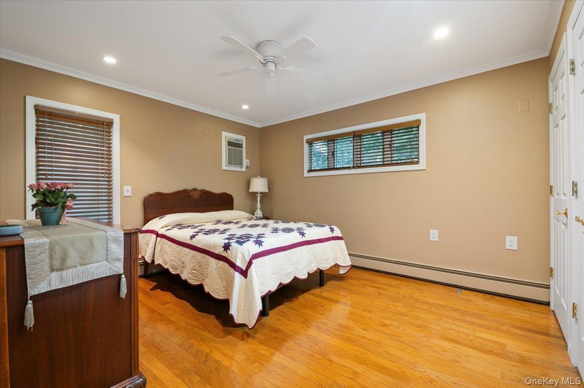 One of Two Primary Bedrooms in this Home! Main Level Primary has Triple Closets and Gleaming Hardwood Floors.