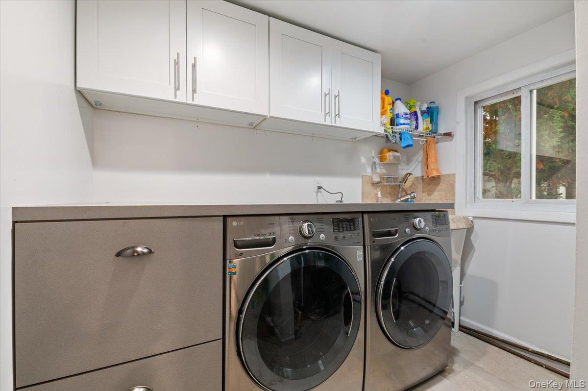 Main Level Laundry with New Washer and Dryer with built in Laundry sorter and lots of storage and work area.