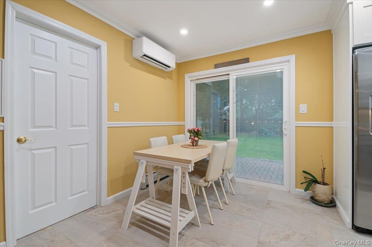 Large Dining Area with Pella Sliders to Yard and Main Level Laundry Access/