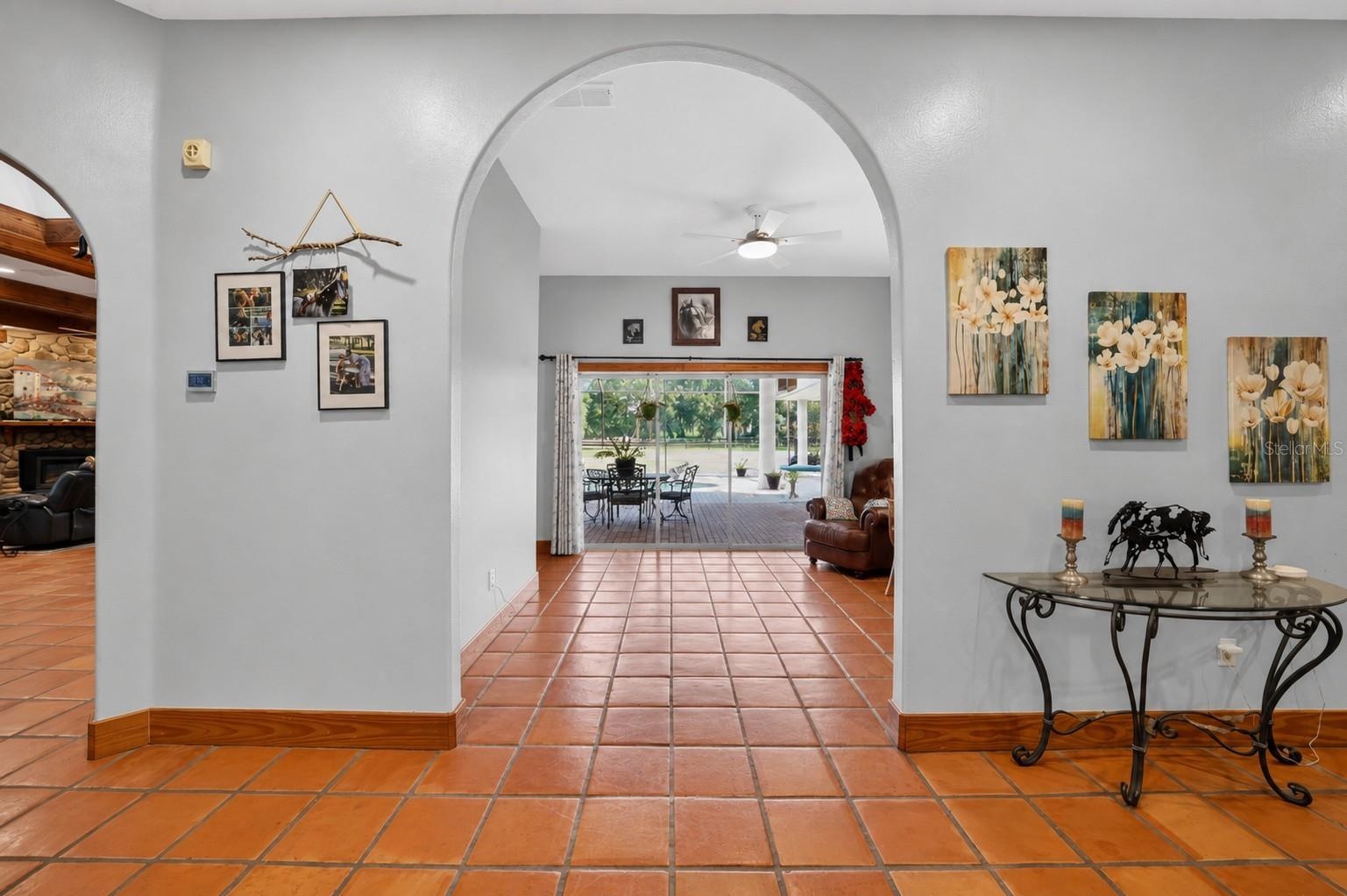 Grand Foyer with Ceramic Floors Throughout and Views Through the Living Room to the Swimming Pool