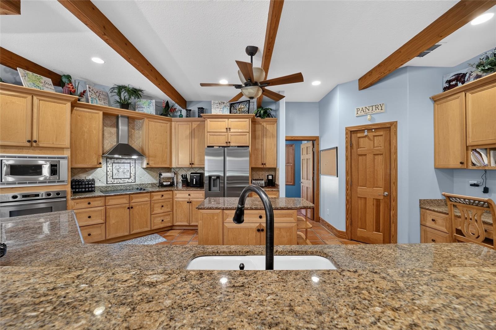 Gourmet Kitchen with Stainless Steel Appliances and Walk-In Pantry
