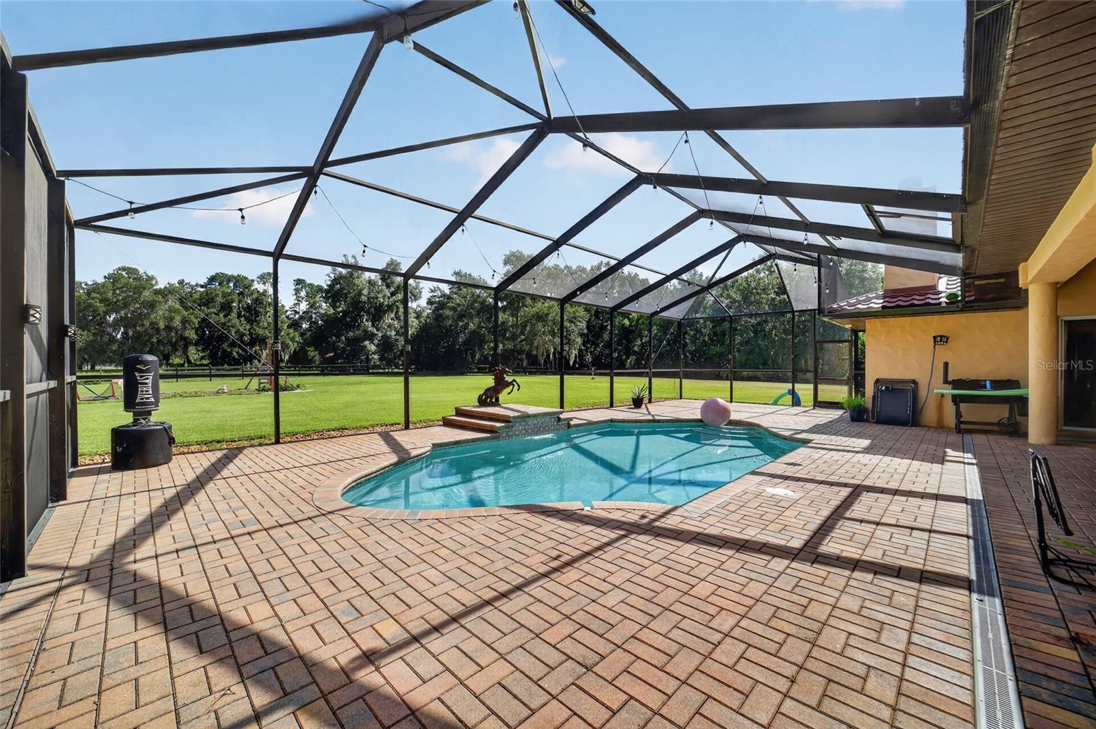 xpansive Covered & Screened Lanai with Paver Pool Deck