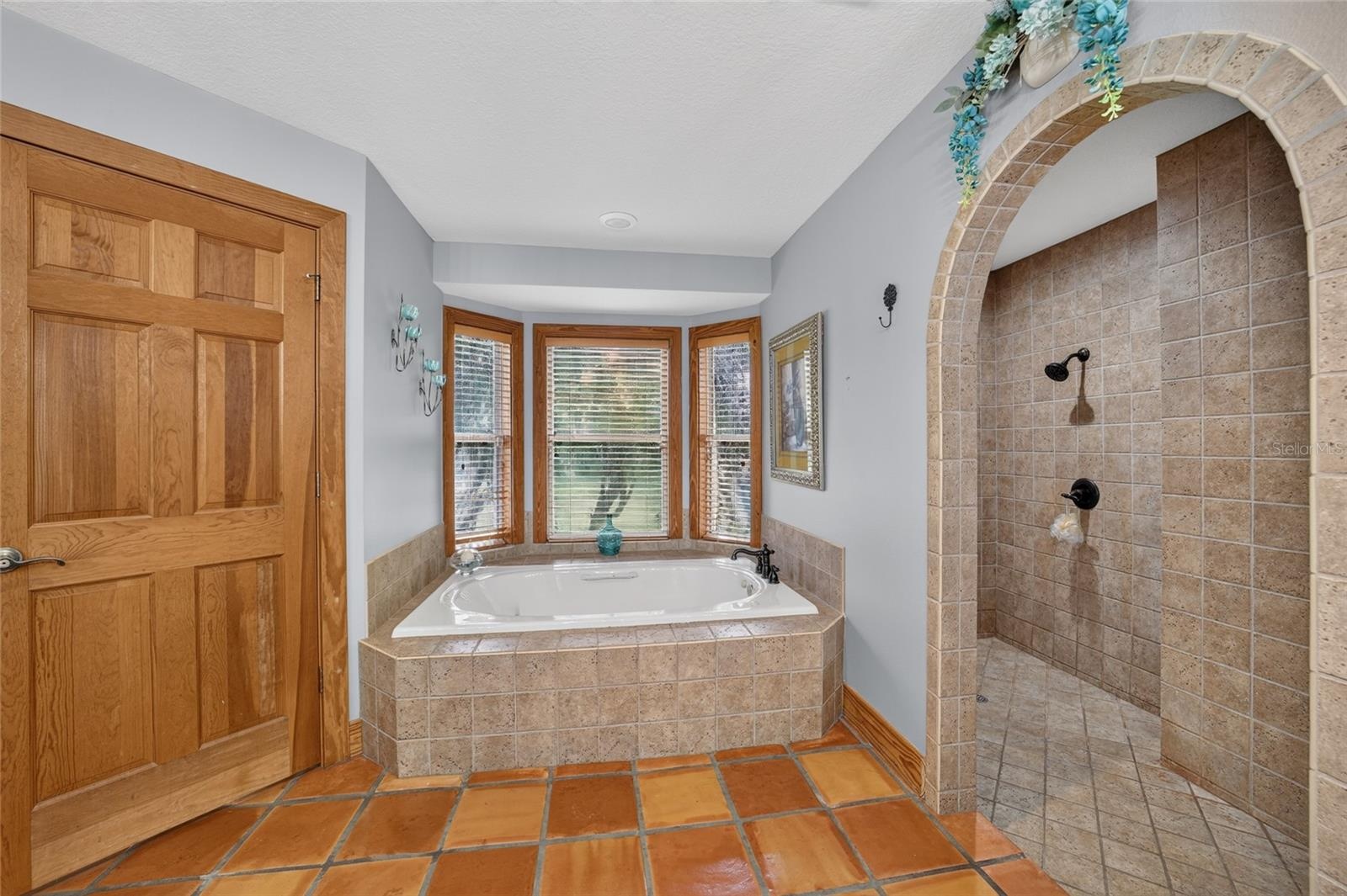 Spa-Inspired Primary Bathroom with Large Soaking Tub, Oversized Walk-In Tiled Shower, Dual Vanities & Private Water Closet