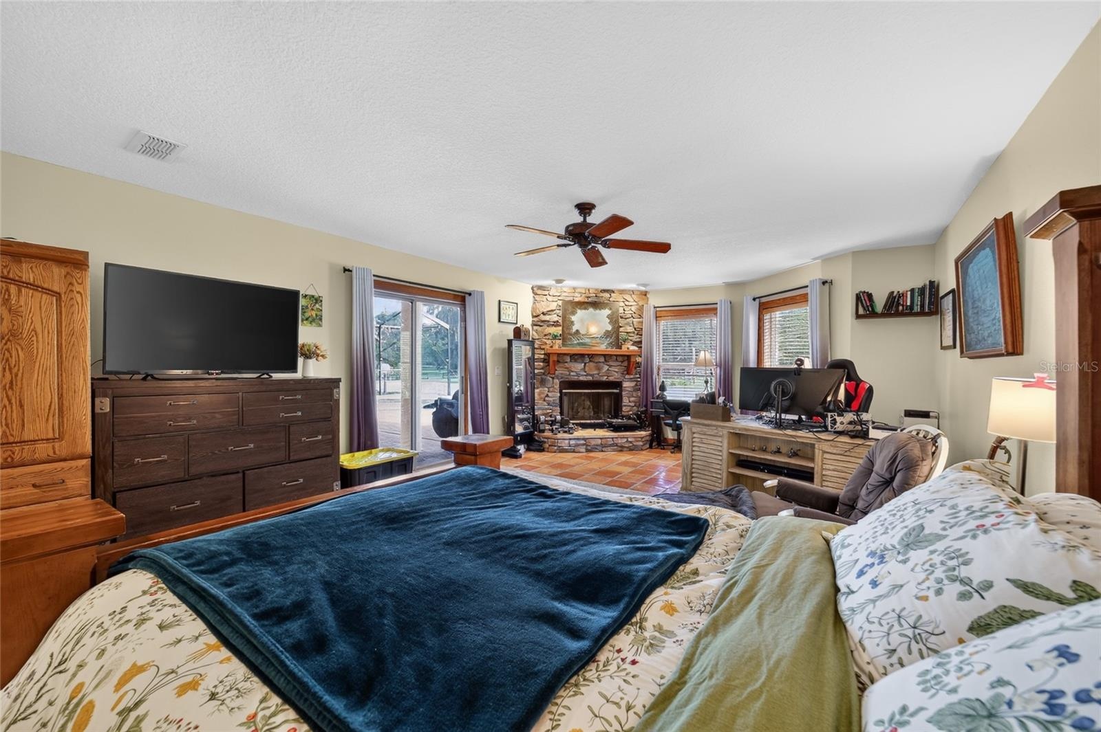 Spacious Primary Suite with Walk-In Closet, Fireplace & Direct Access to the Lanai and Swimming Pool