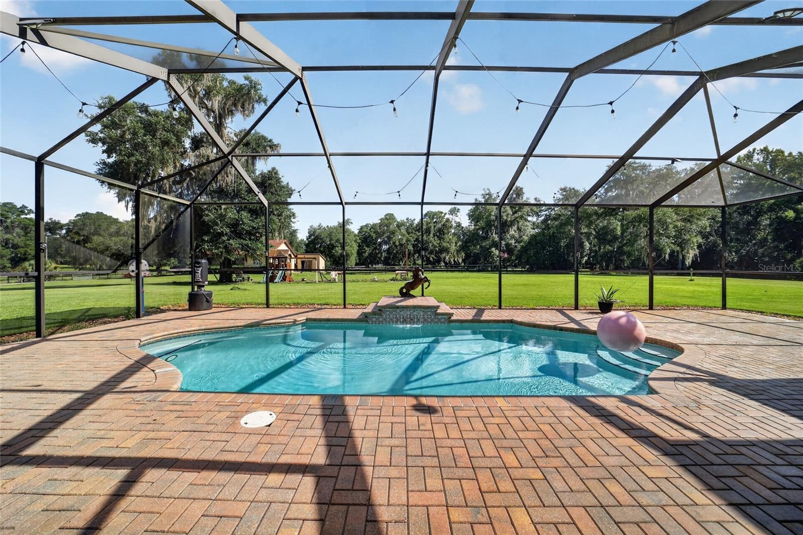 Expansive Covered & Screened Lanai with Paver Pool Deck