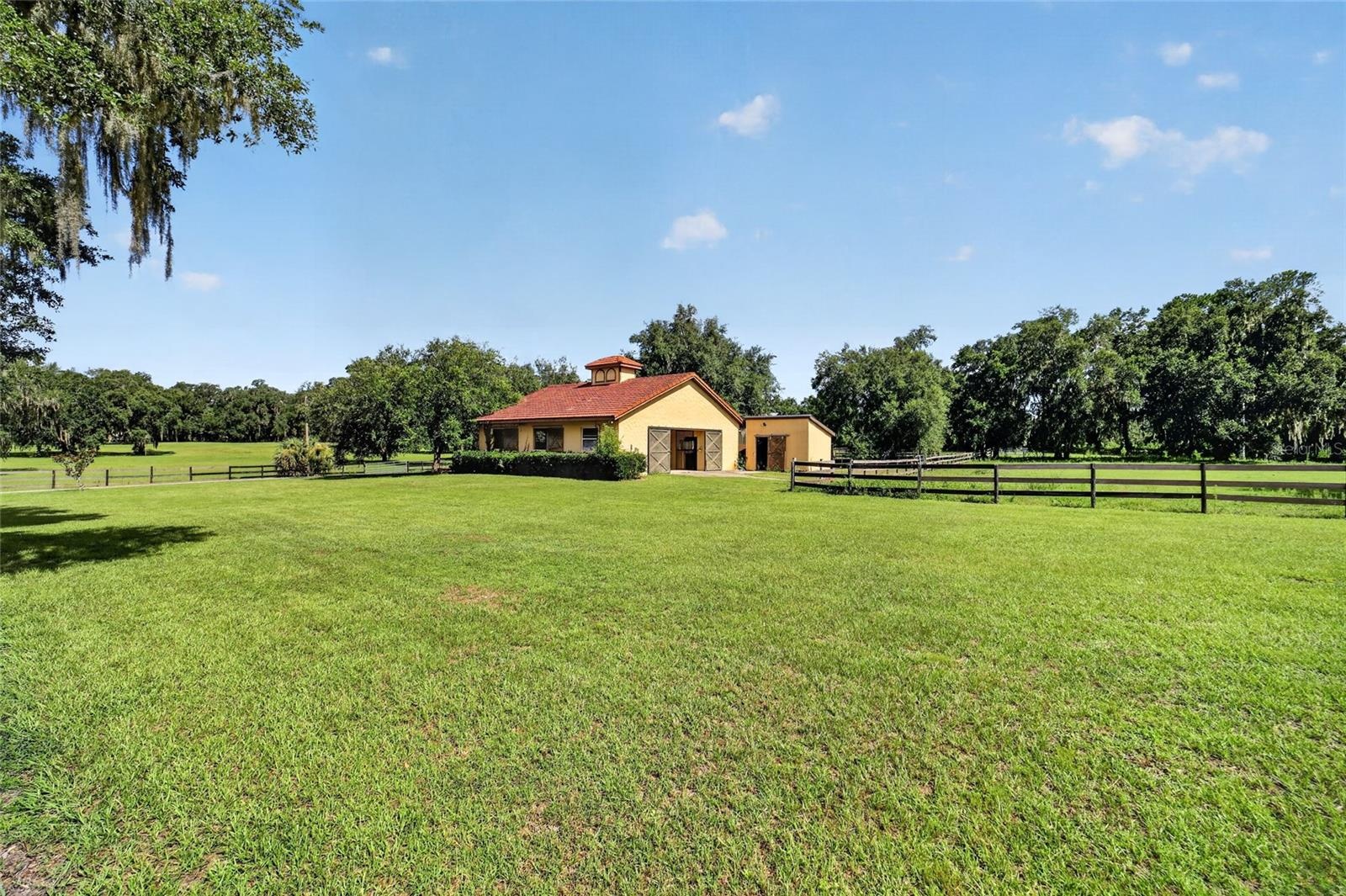 Groomed Backyard with Playground and 5-Stall Center-Aisle Barn