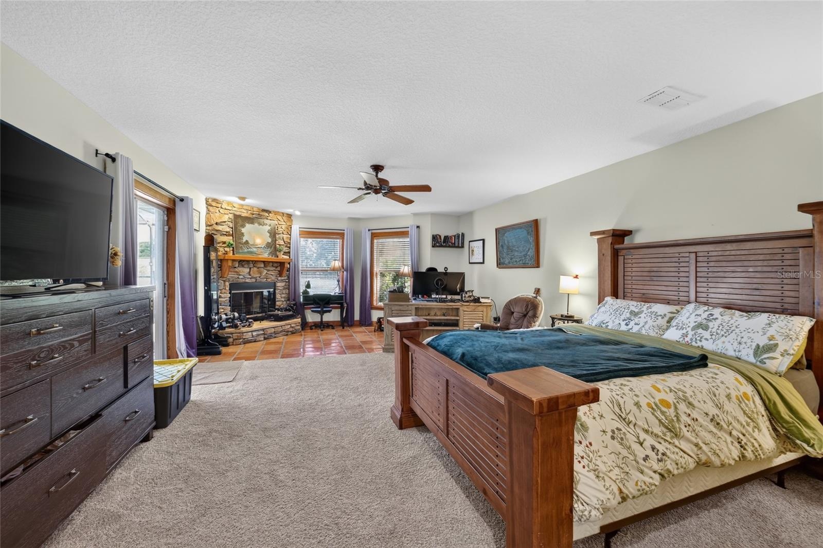 Spacious Primary Suite with Walk-In Closet, Fireplace & Direct Access to the Lanai and Swimming Pool