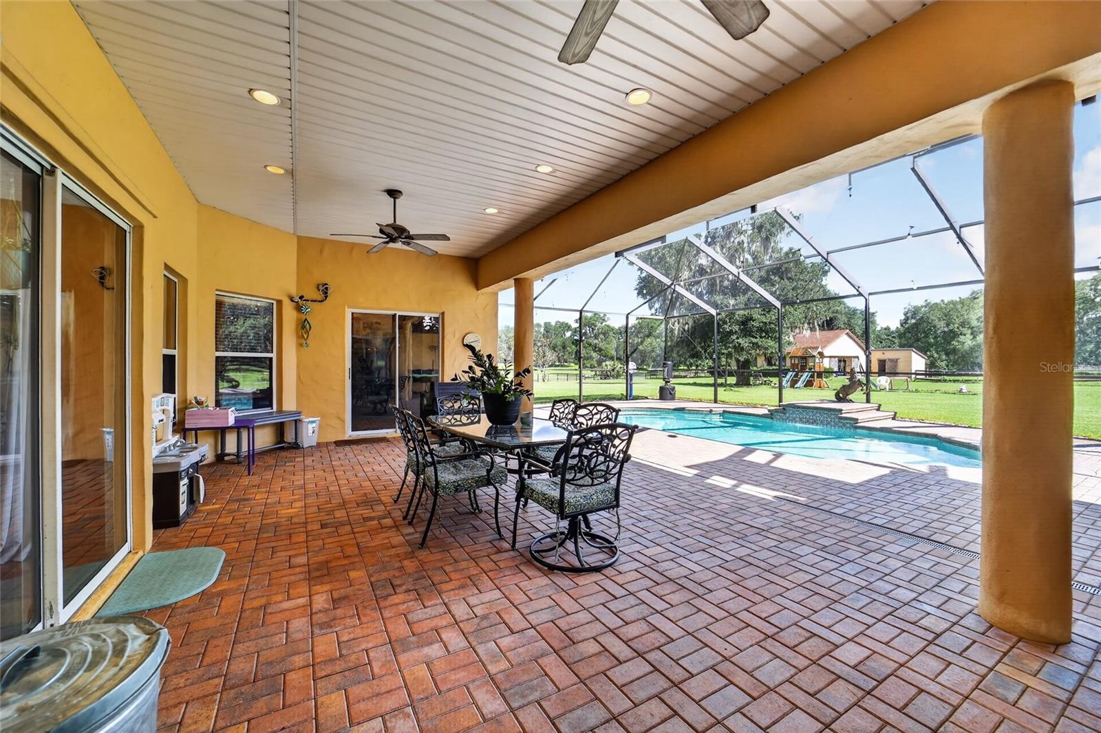 Expansive Covered & Screened Lanai with Paver Pool Deck