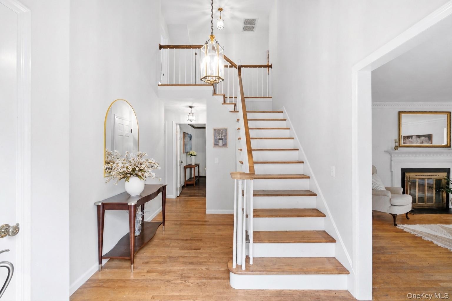 Step into a welcoming foyer that sets the tone for the home with an open feel, wood floors throughout and thoughtfully designed interior.