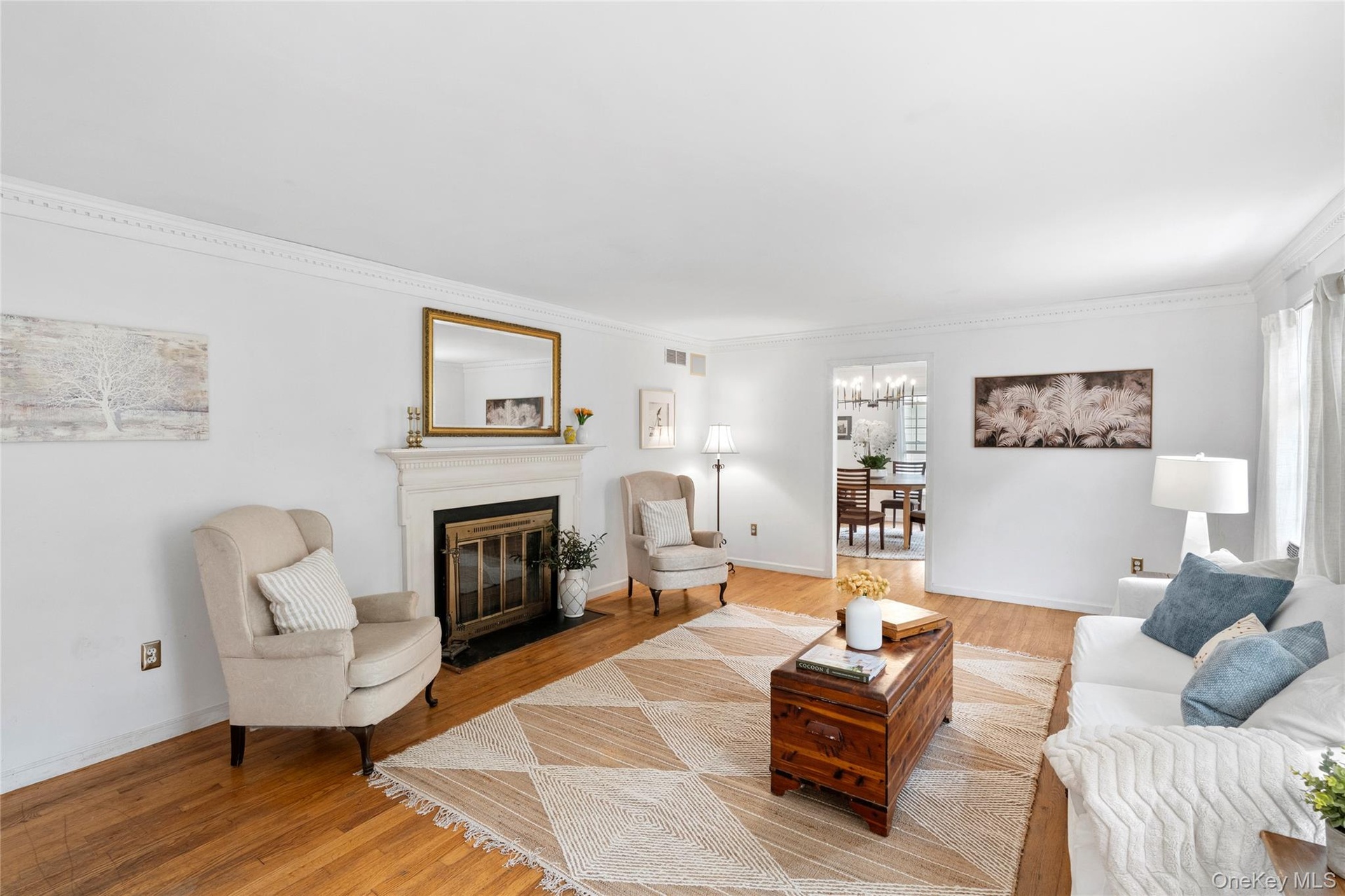 A warm and inviting living room centered around a beautiful fireplace and hardwood floors throughout..