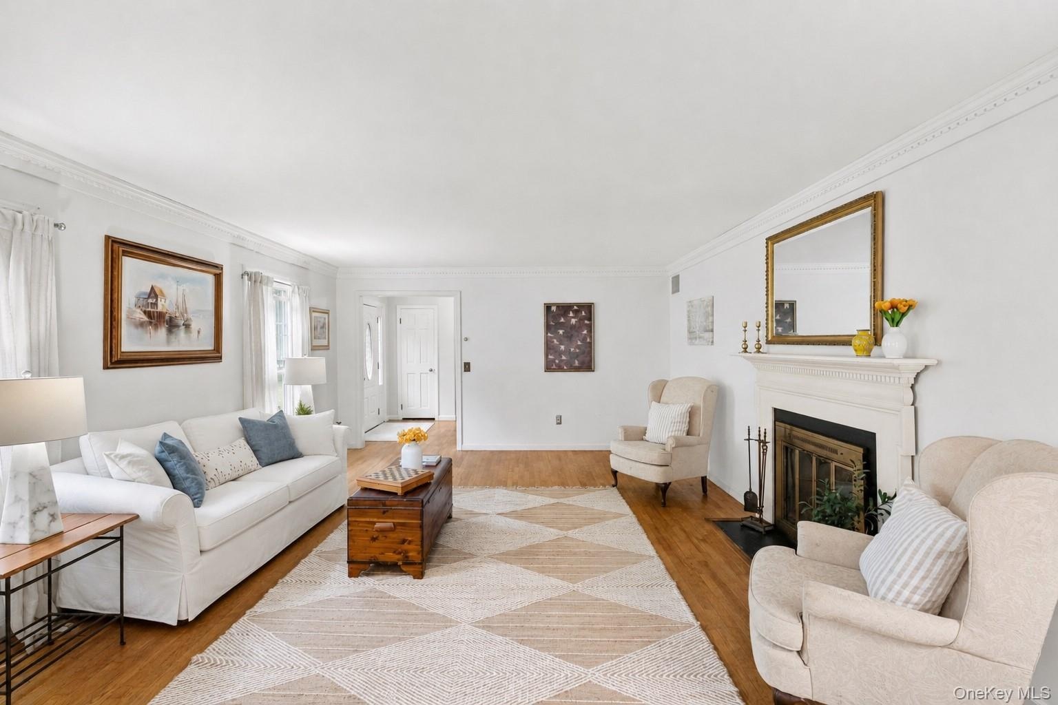 The spacious living room is anchored by a charming fireplace, perfectly blending the timeless character.