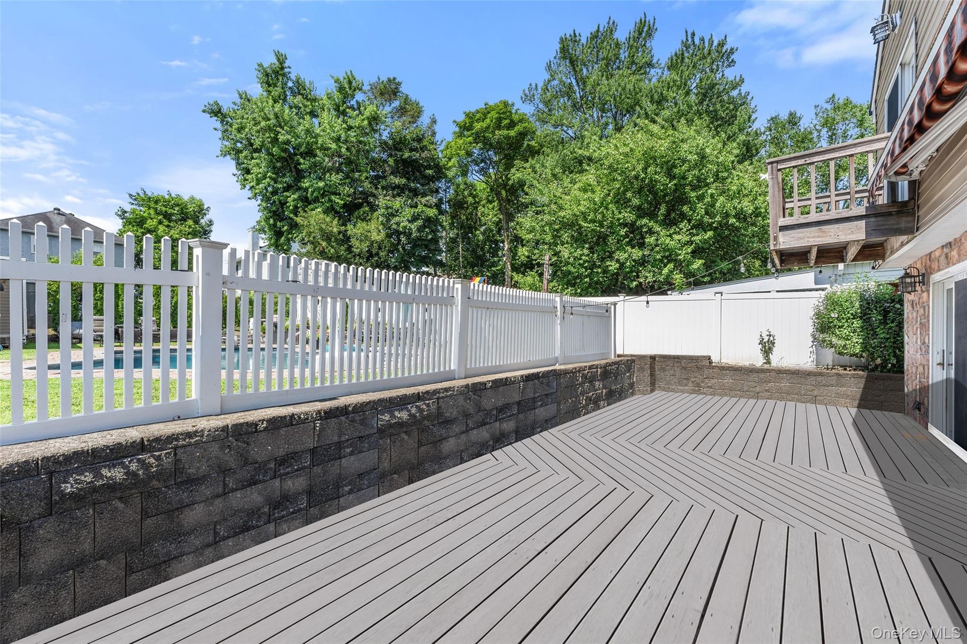 Expansive deck with access to the family room and the dine-in kitchen.