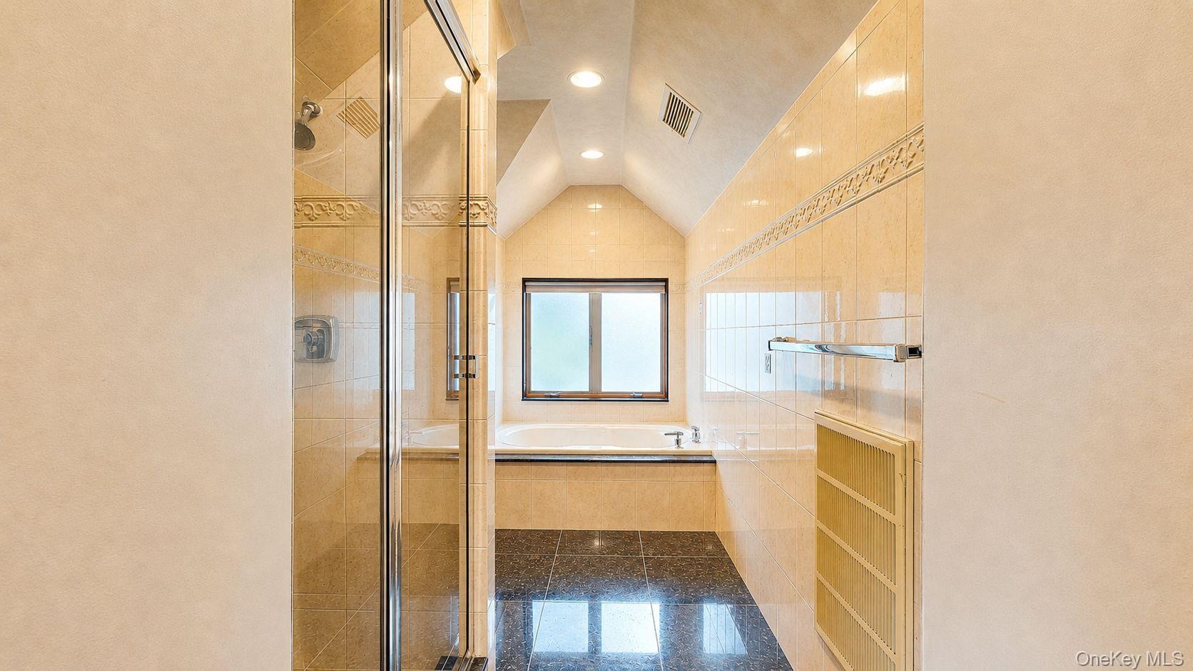 Bathroom featuring a glass-enclosed shower, a built-in soaking tub, tile flooring, recessed lighting, and a frosted window