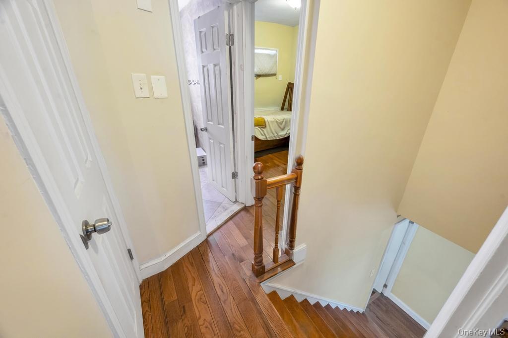 Wood-finish flooring throughout the hallway