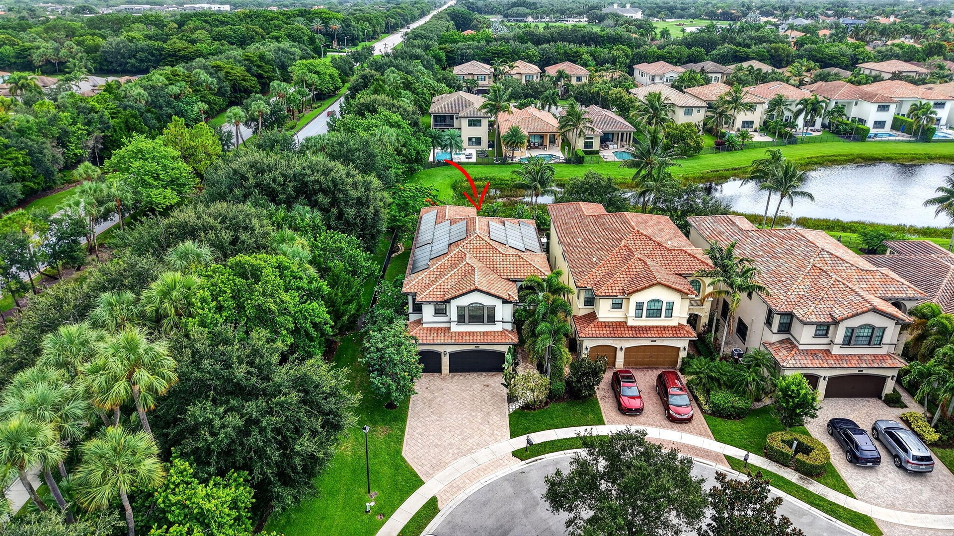 Mediterranean-style residence with a red tile roof and solar panels