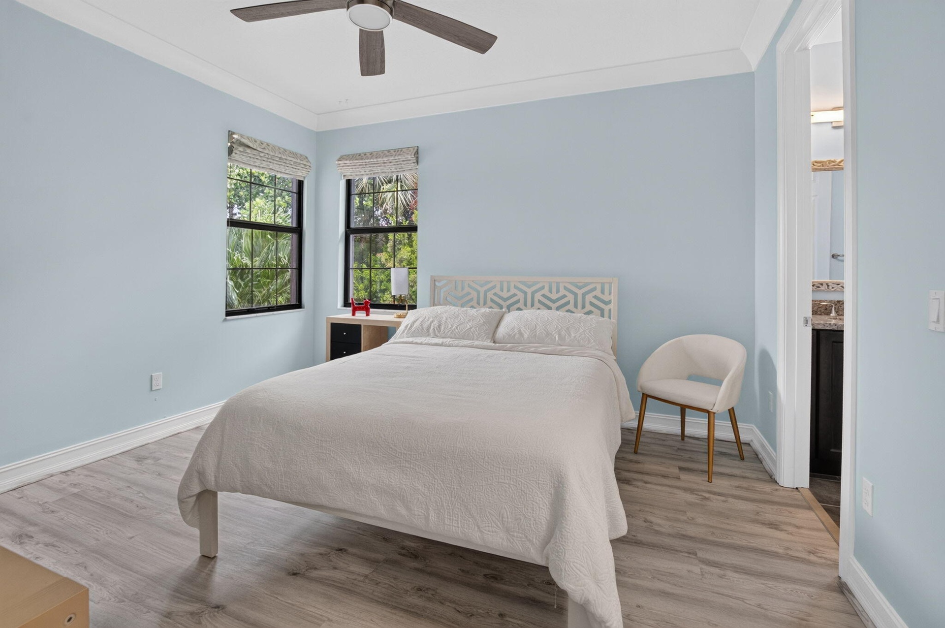 Interior room featuring light blue walls and wood-finish flooring