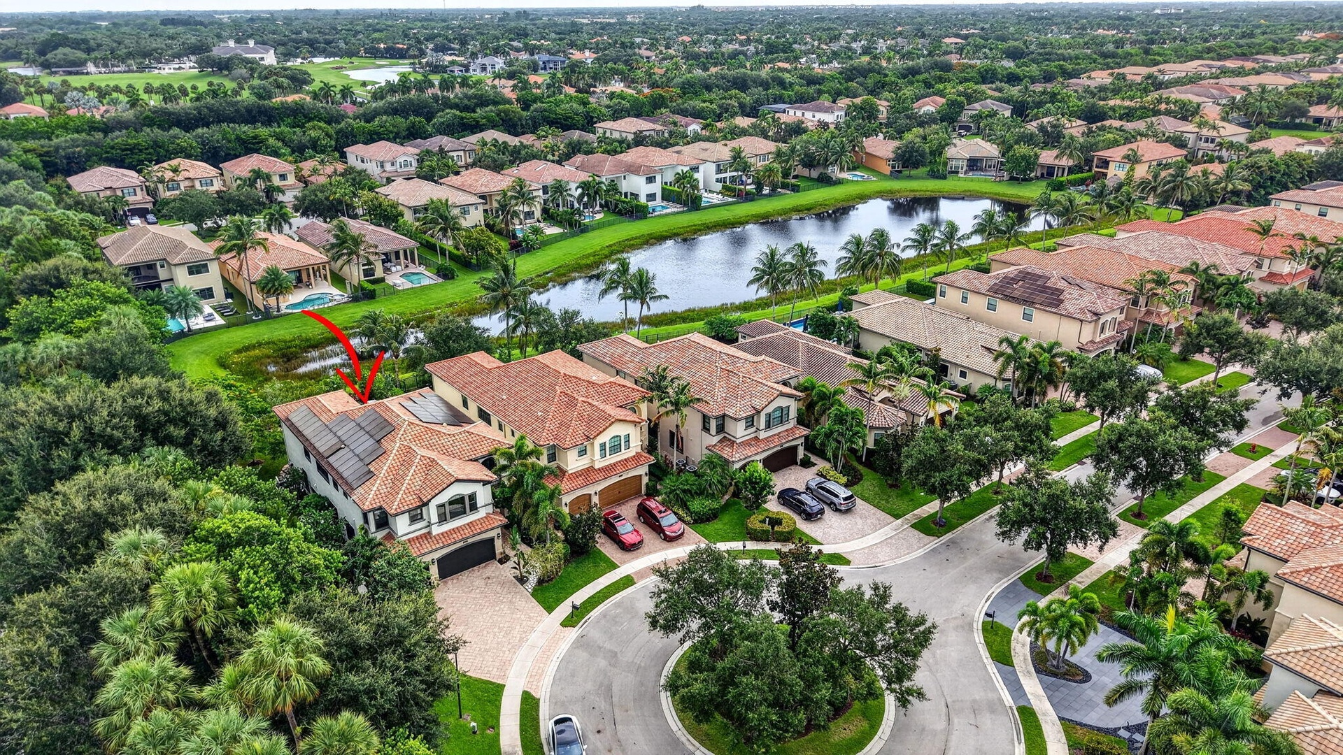 Mediterranean-style residence featuring a tile roof and solar panels