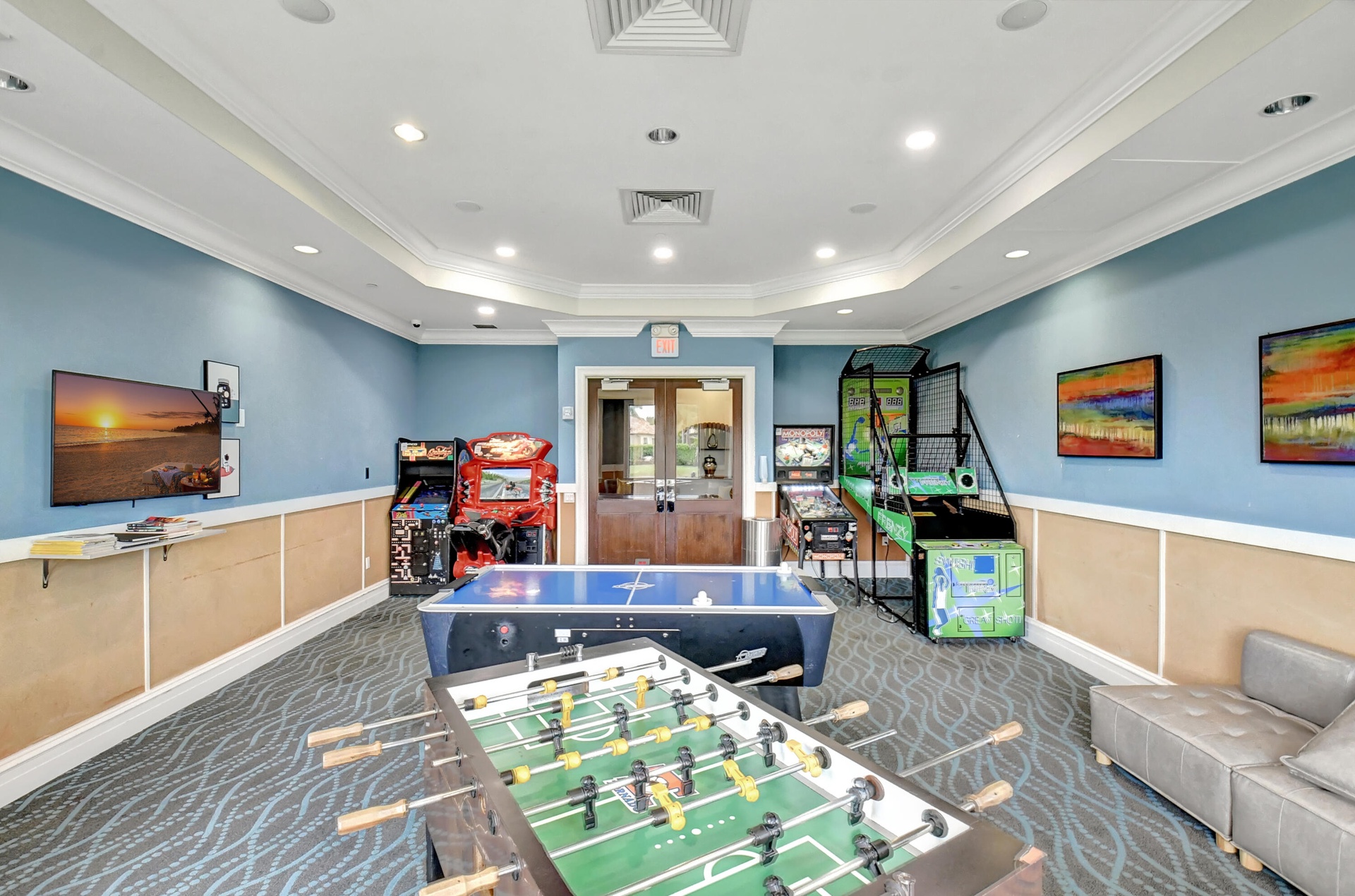 Recreation room featuring patterned carpet, light blue walls with wainscoting, recessed lighting, and crown molding