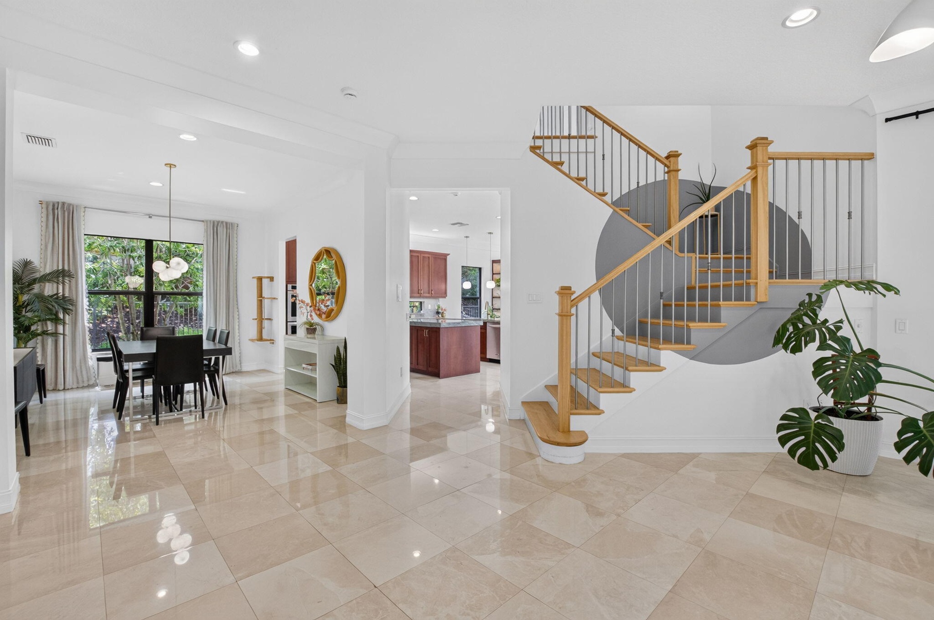 Curved staircase with natural wood treads and metal balusters