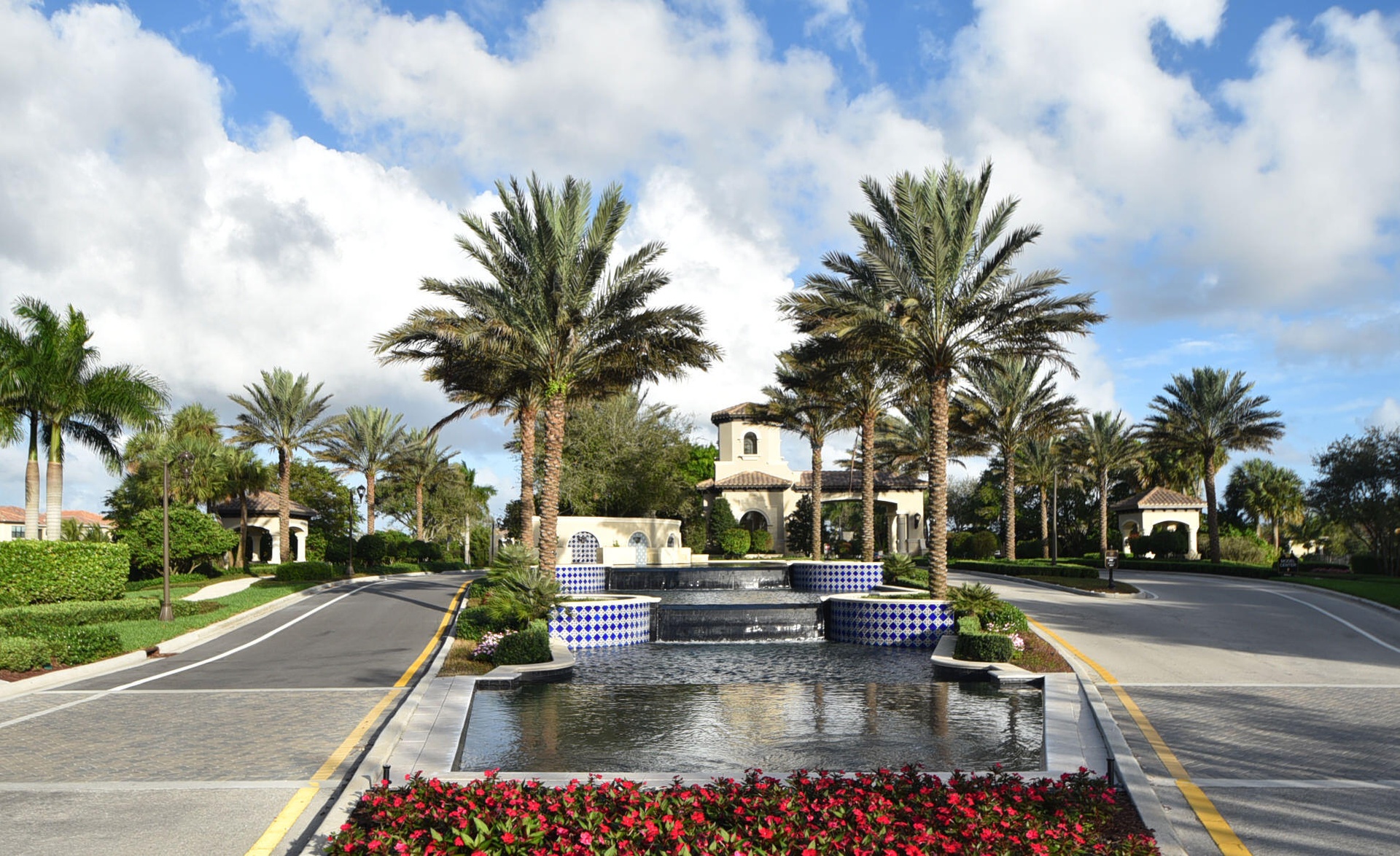 Grand entry featuring a multi-tiered fountain with blue and white mosaic tile accents