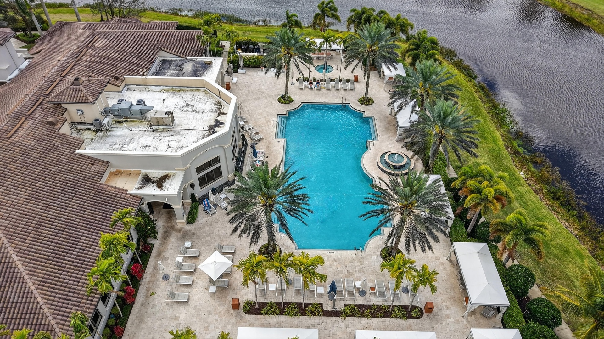 Expansive pool area featuring a freeform swimming pool, integrated fountain, and a circular spa