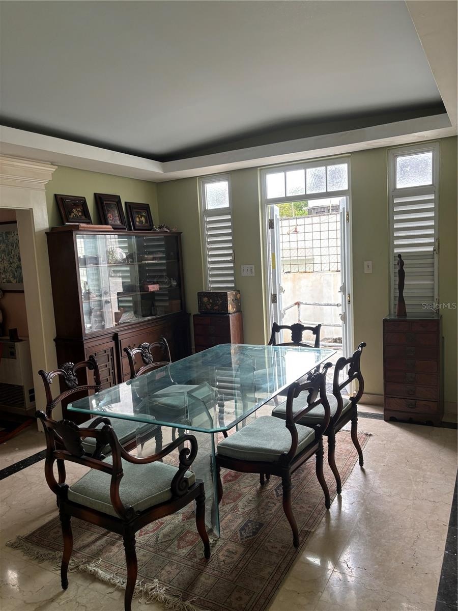 Formal Dining Room with doors to the back yard gardens.