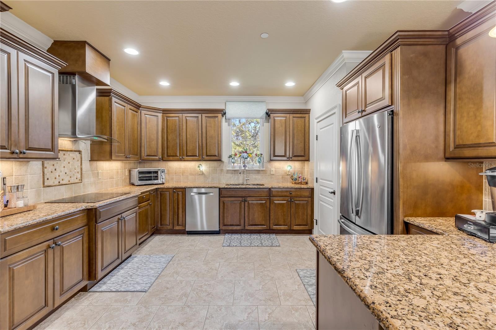 wood cabinets, granite countertops, tile backsplash