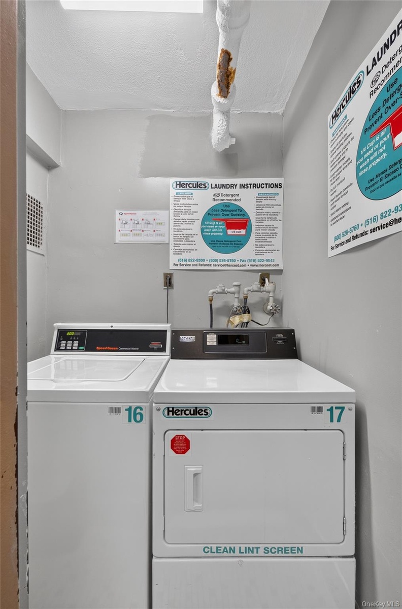 Dedicated laundry room featuring a top-loading washing machine and a front-loading dryer