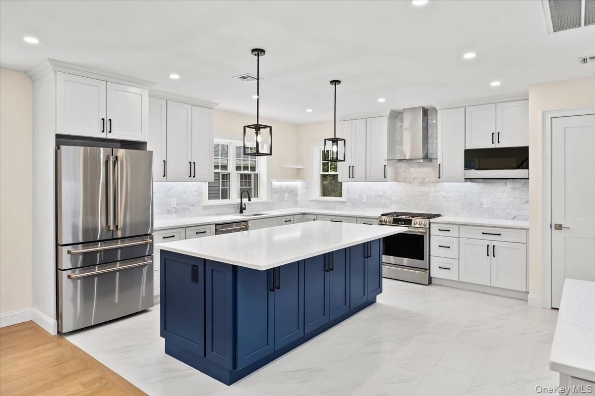 Bright formal dining area and kitchen transition layout, featuring premium quartz counters and open space with optional builder customization for arch
