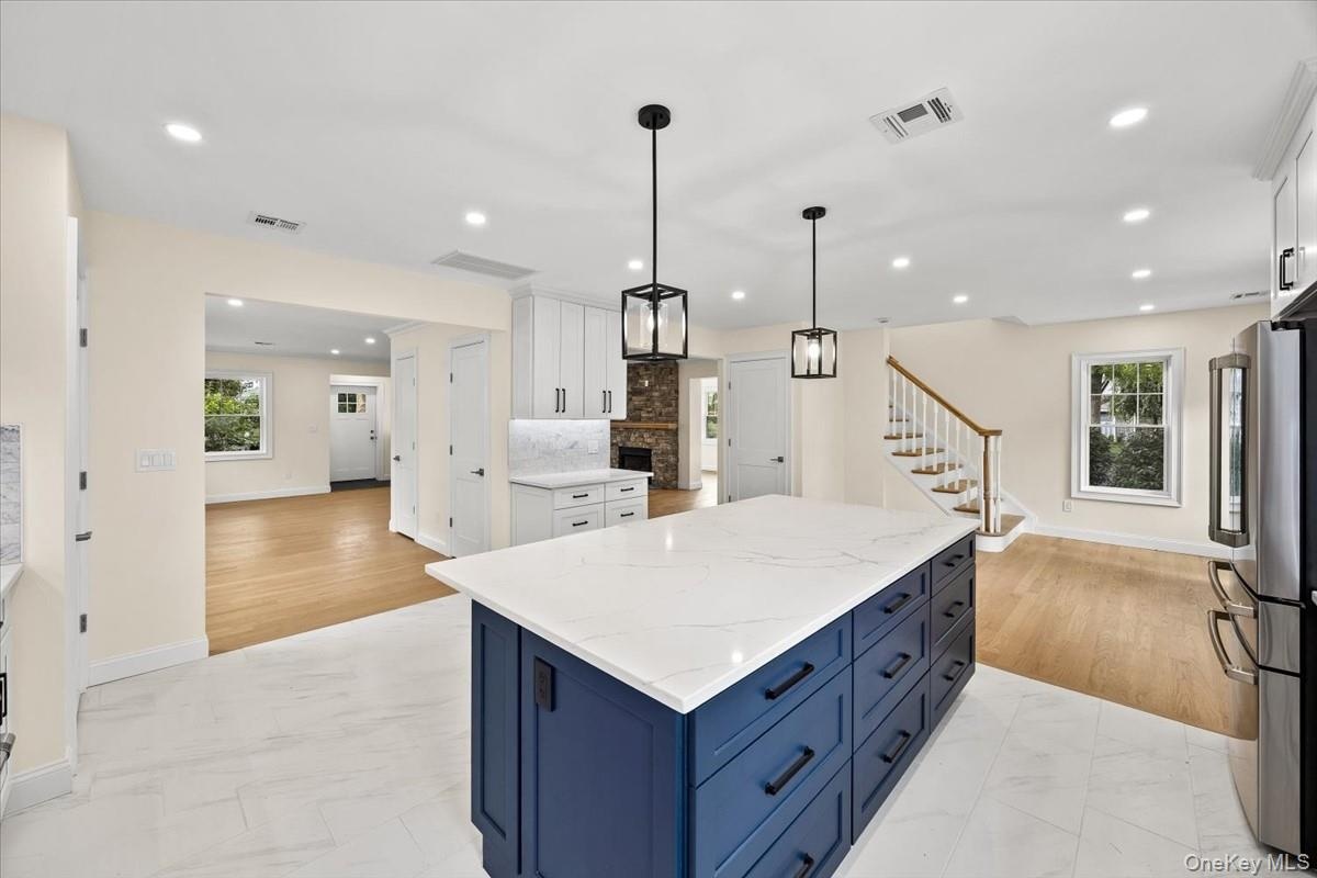Bright formal dining area and kitchen transition layout, featuring premium quartz counters and open space with optional builder customization for arch