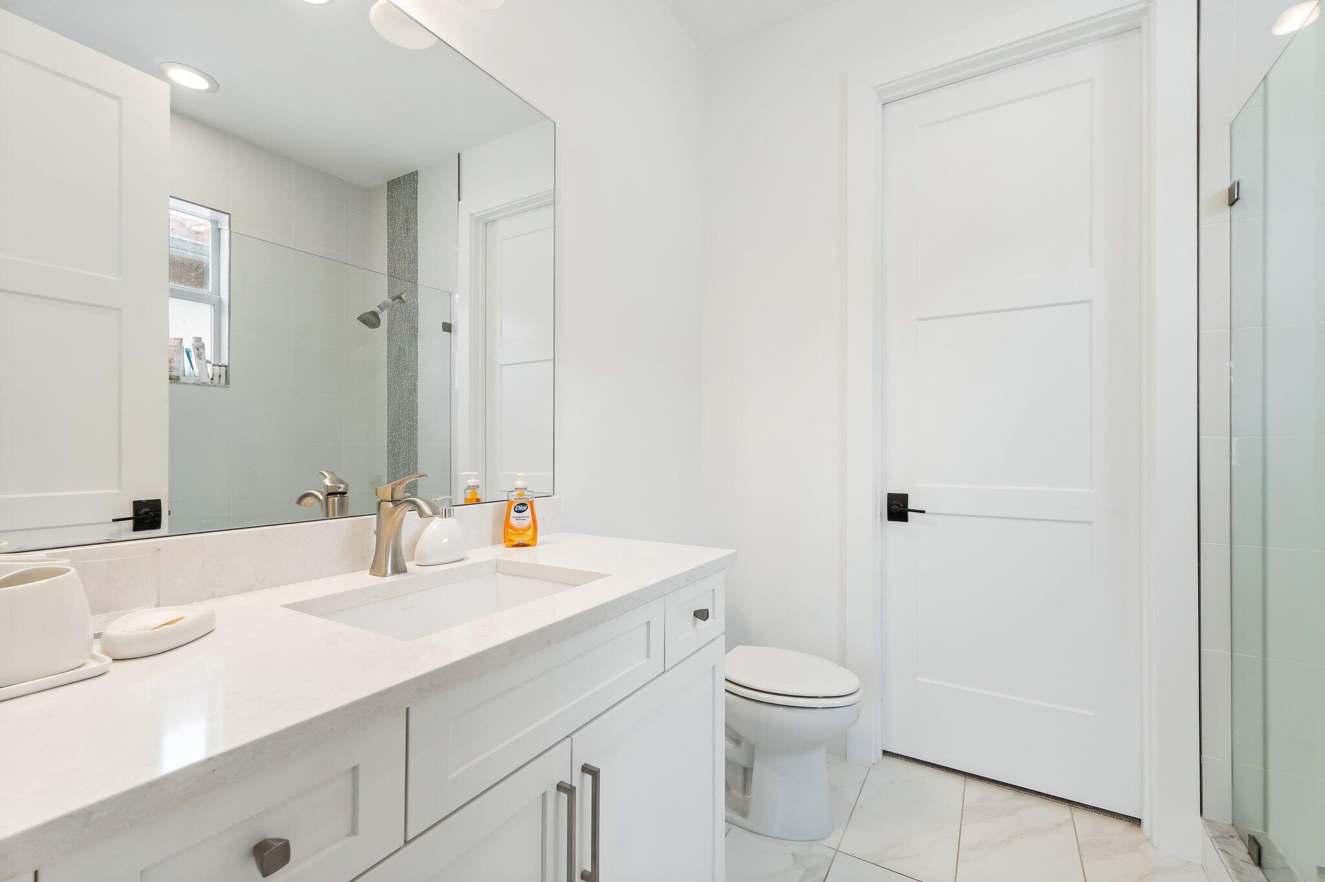Bathroom with white cabinetry, single vanity, and tile flooring