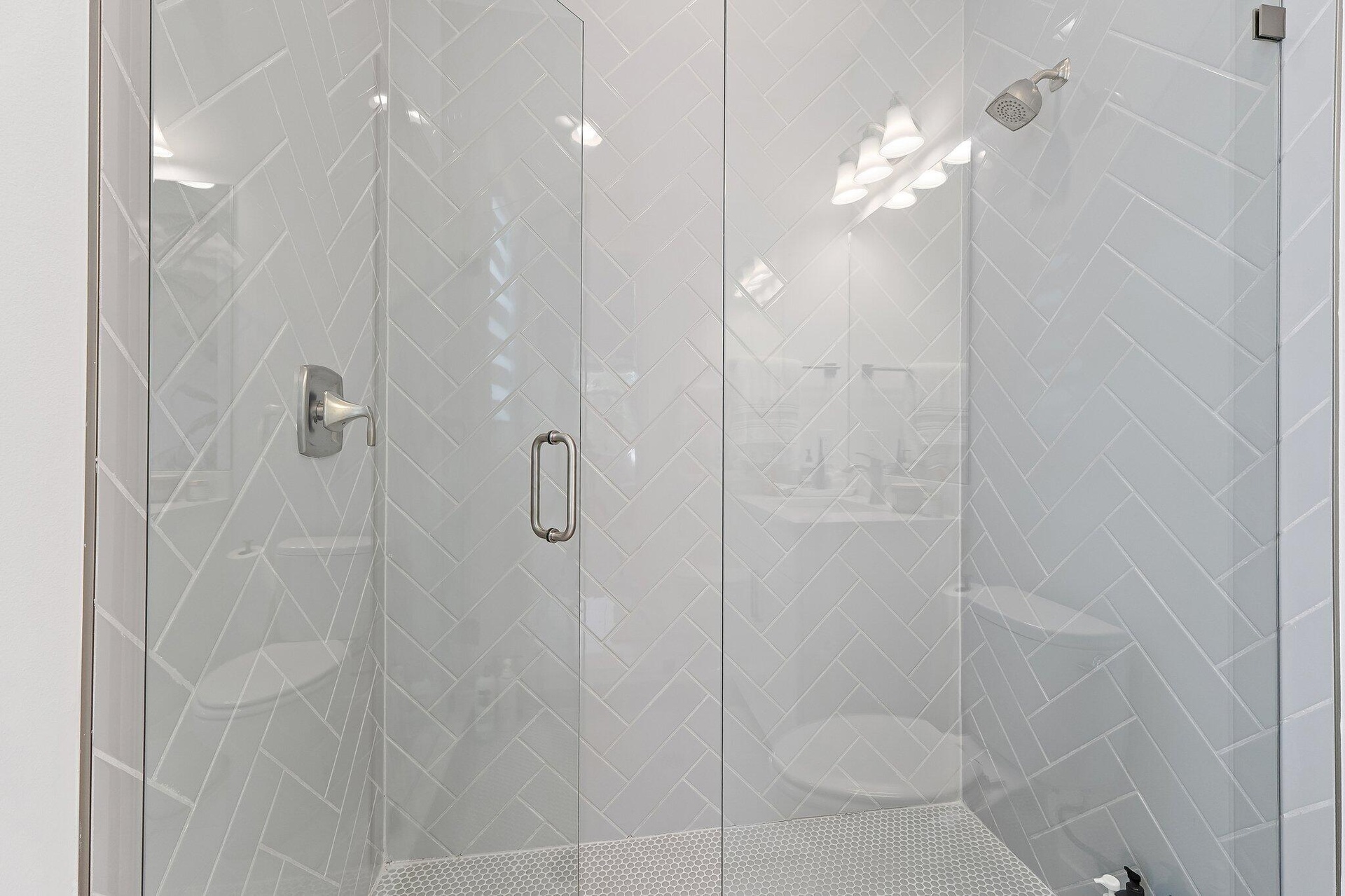 Glass-enclosed shower with tile surround
