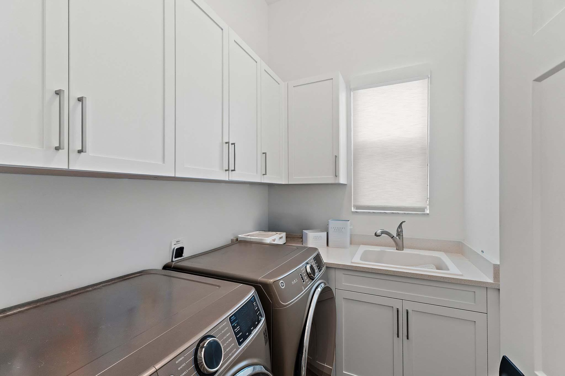 Laundry room with washer, dryer, and farmhouse sink