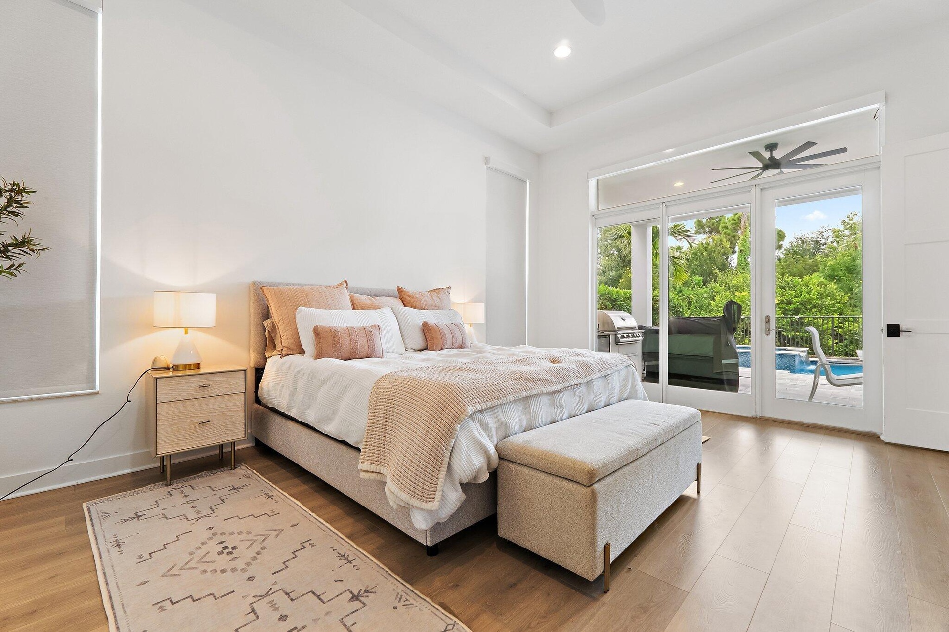 Primary bedroom with king bed, ceiling fan, and sliding glass doors to outside