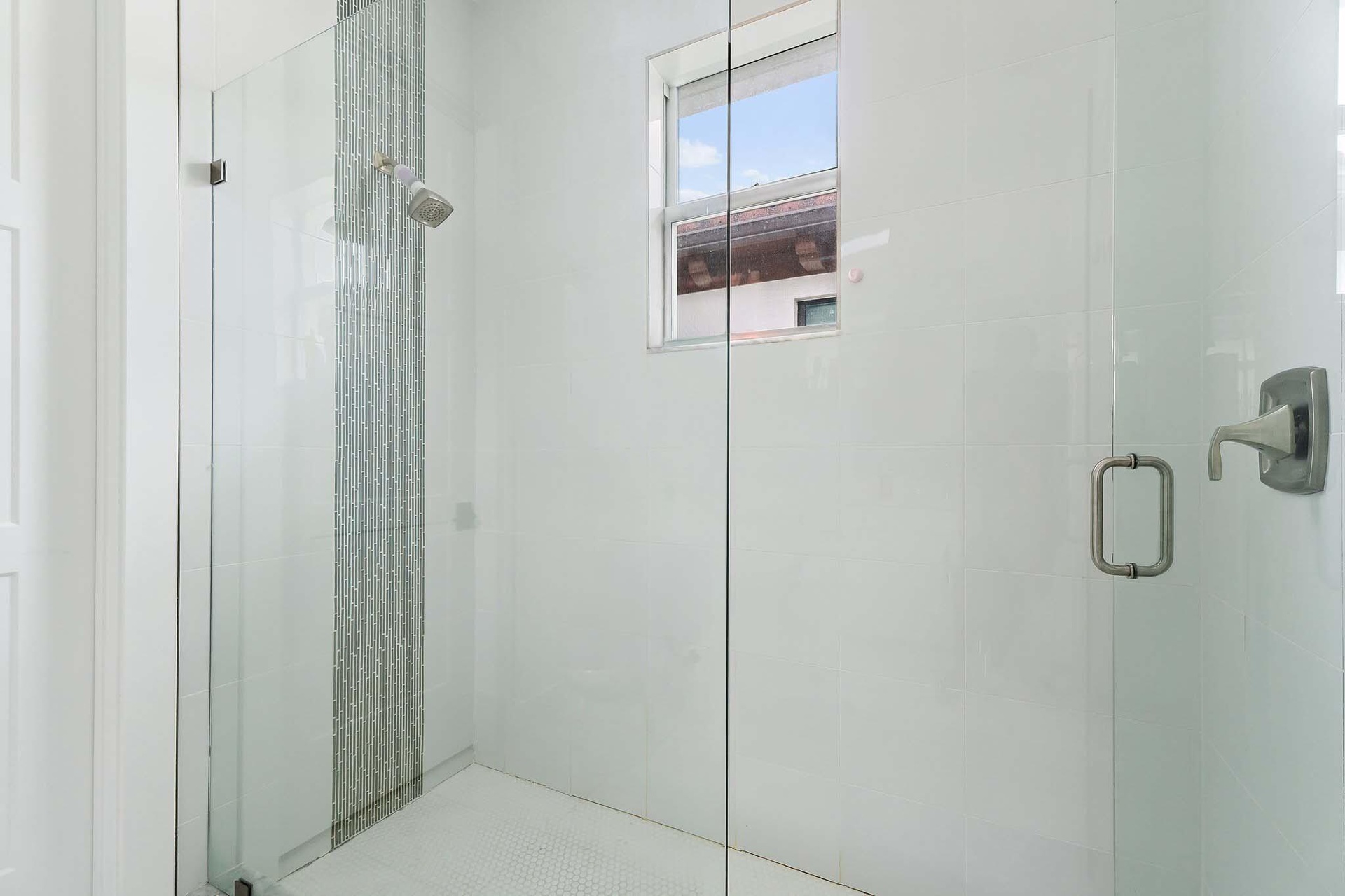 Glass-enclosed shower with window
