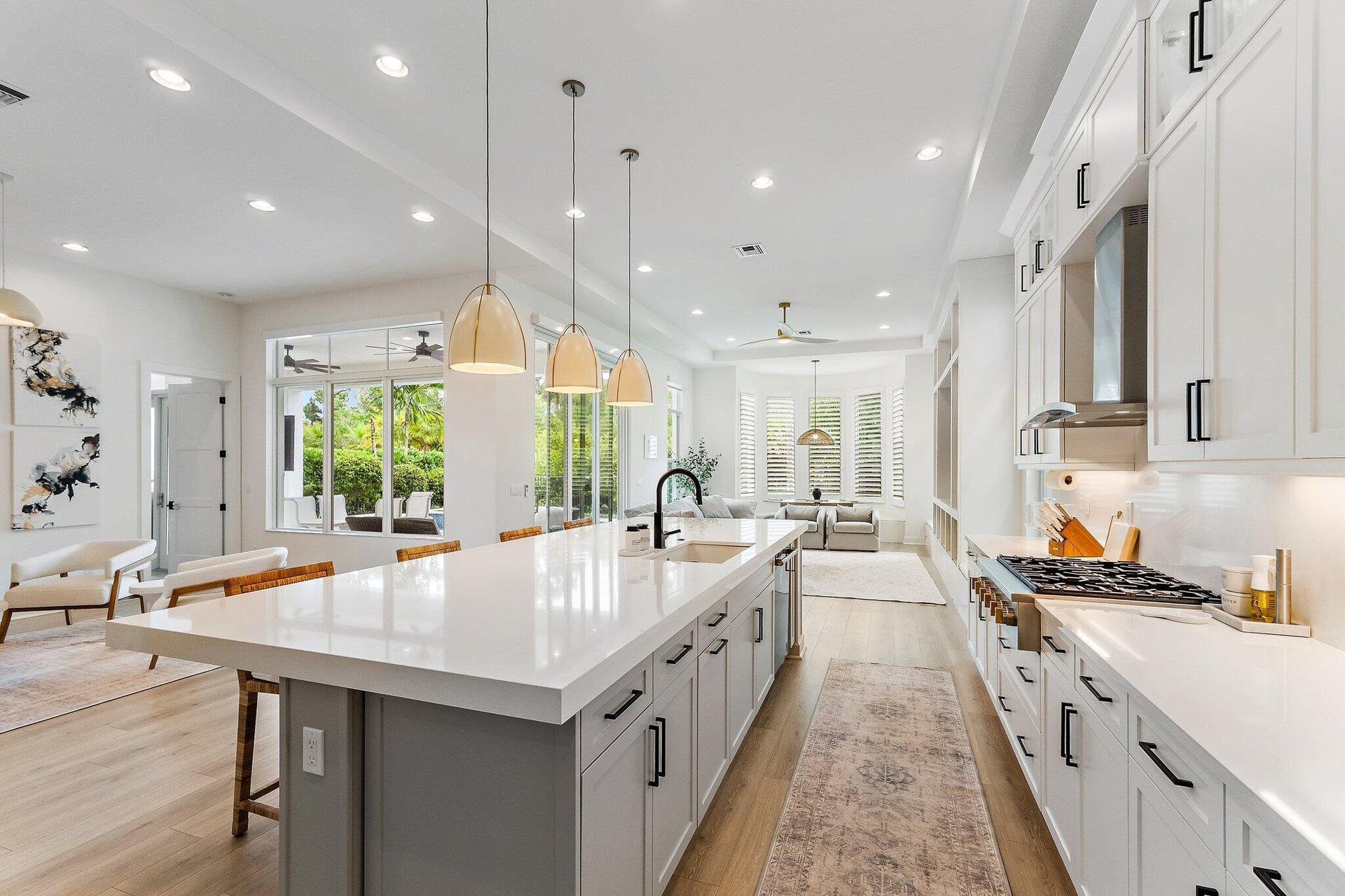 Kitchen with large island, pendant lighting, and view to adjoining living area