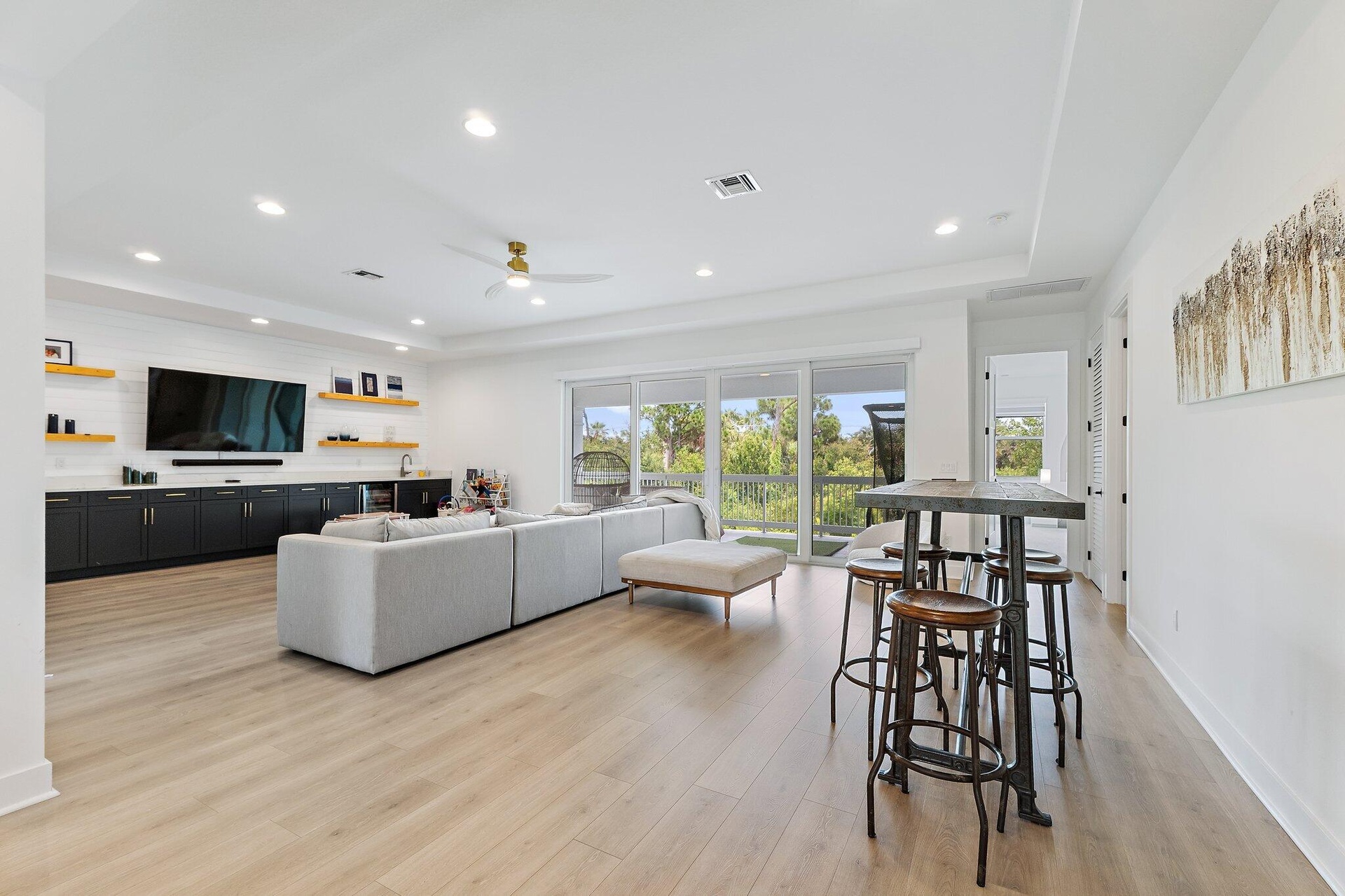 Bonus room with kitchenette, seating area, and high-top bar table with stools