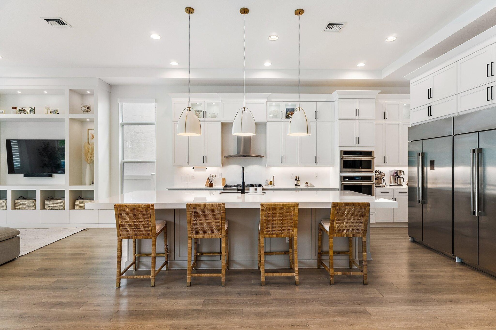 Kitchen with wood dining table, mounted TV, and dark cabinetry