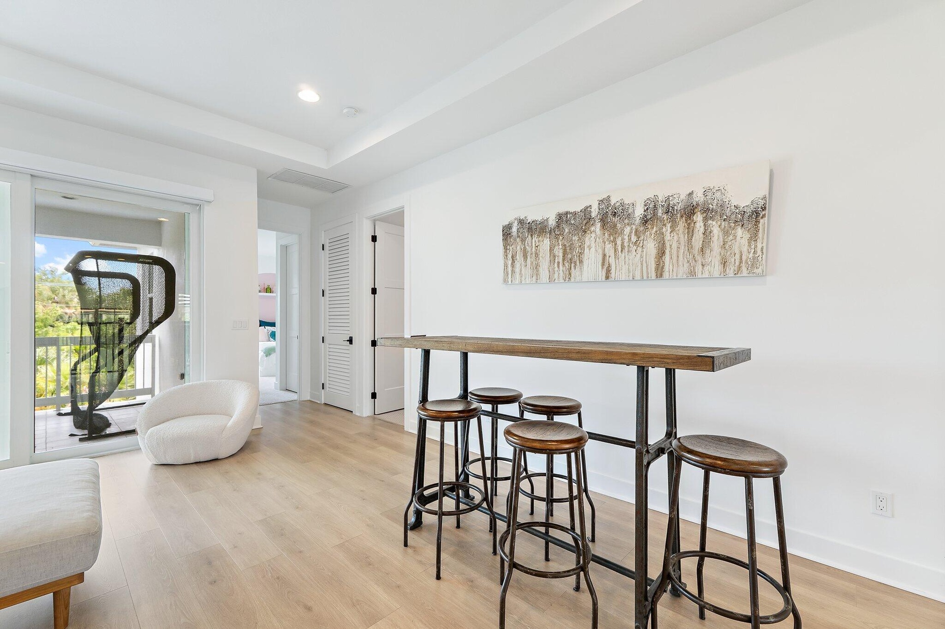 Bonus room with high-top bar table, stools, and exercise equipment