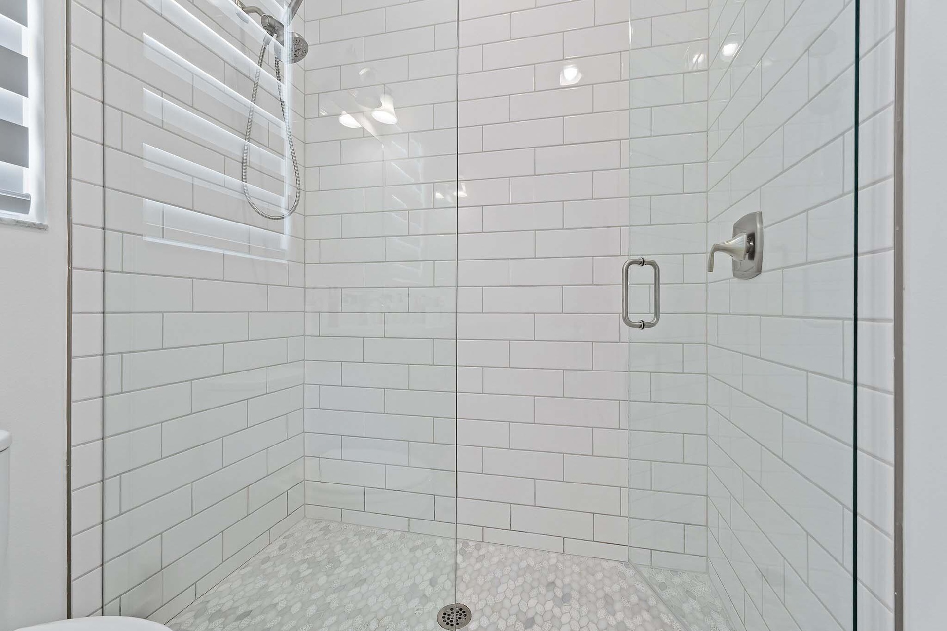 Subway tile shower with glass door