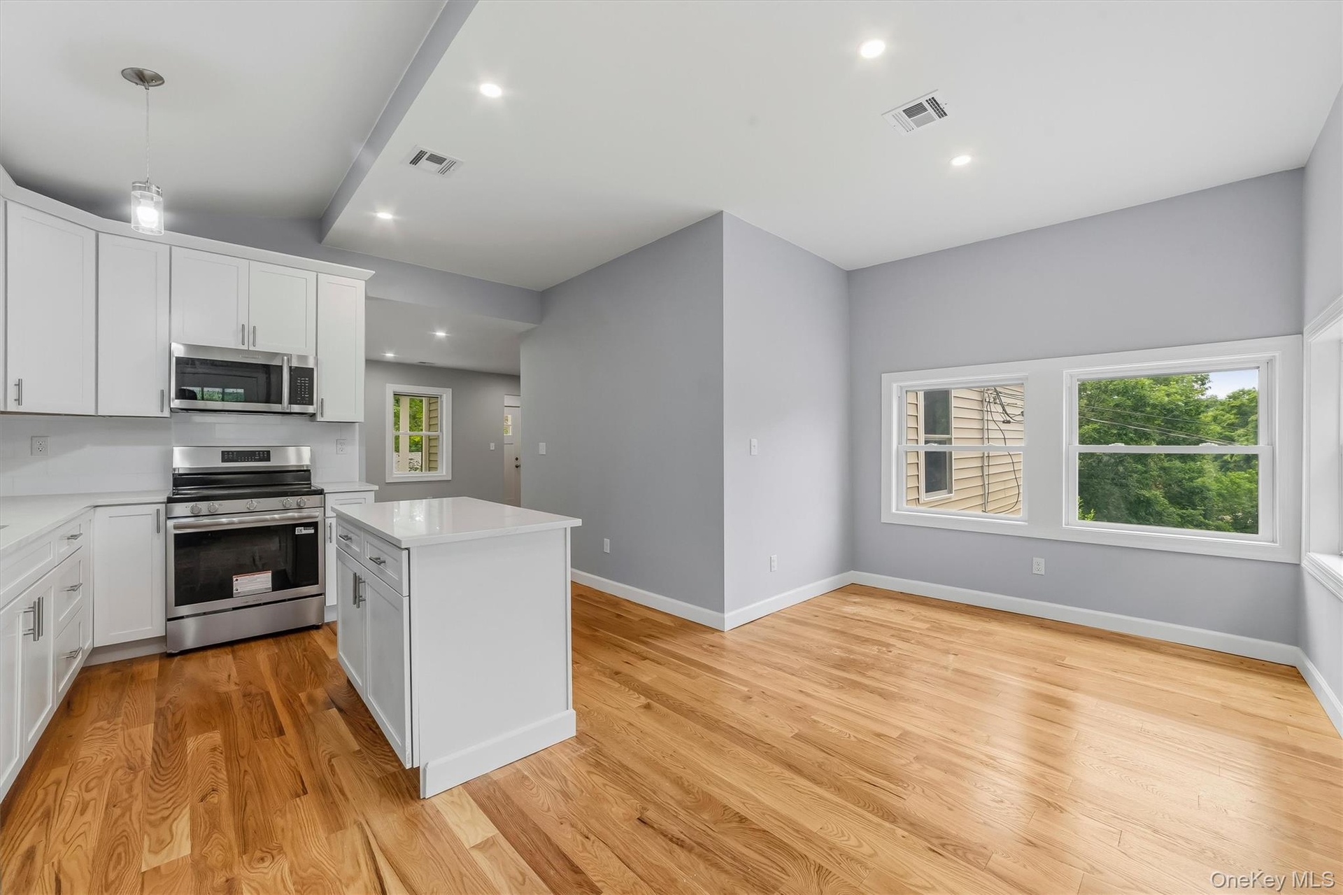Totally new EIK with SS appliances, Quartz counter tops, island & door to porch