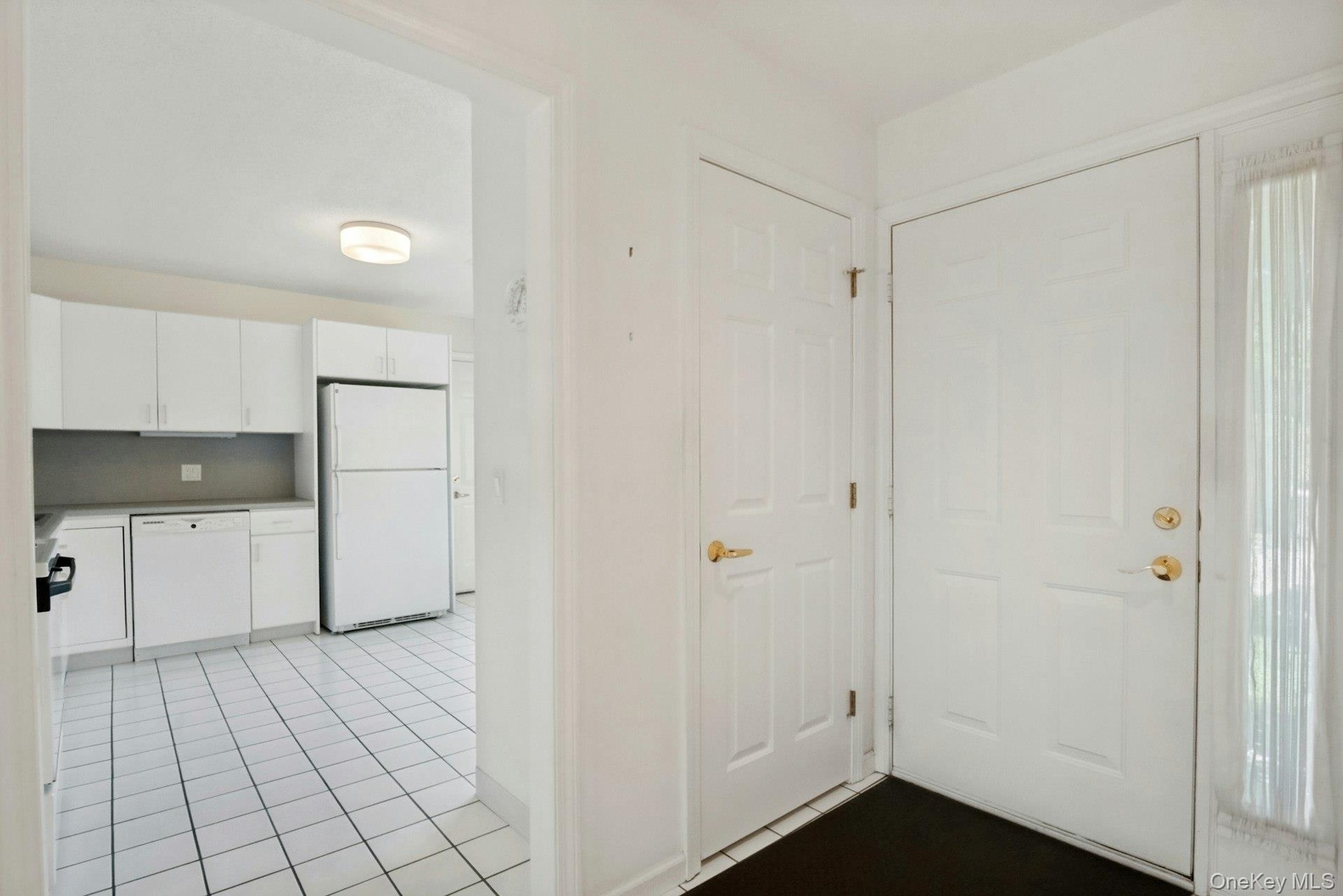 Entrance Foyer with coat closet and white tiled floor