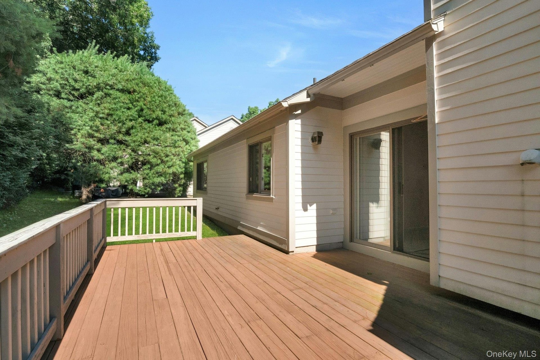 Oversized deck from the sliding glass doors in the Living room & access to private yard