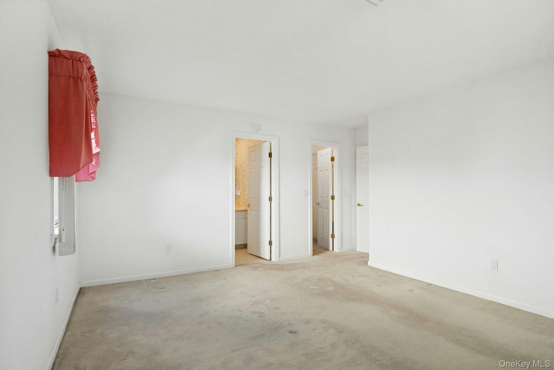 Another view of the Primary Bedroom with a view to the generous wall space.