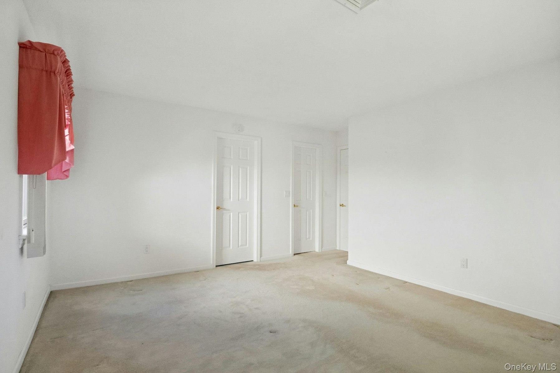 Another view of the Primary Bedroom with a view to the generous wall space