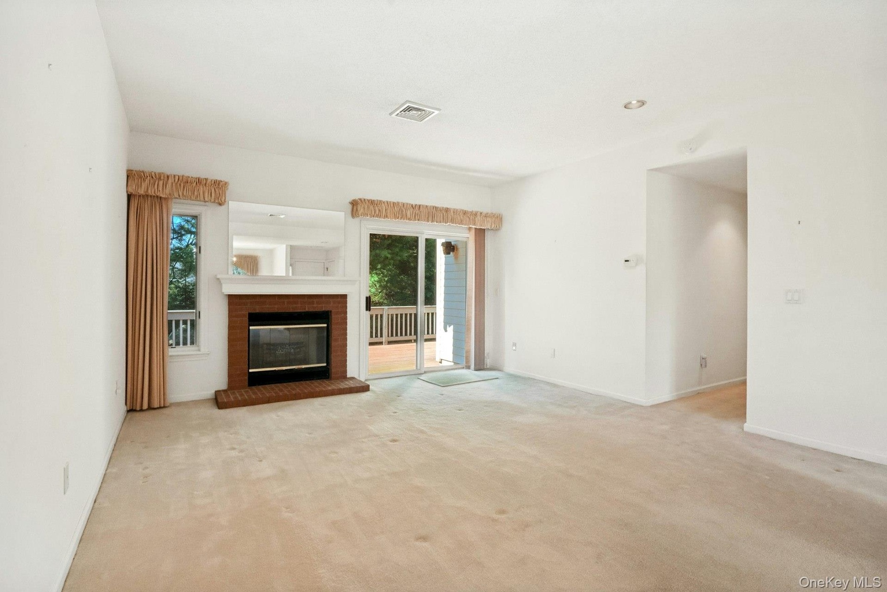 Living room with fireplace*,recessed lights & view to hallway/laundry/  bedroom area