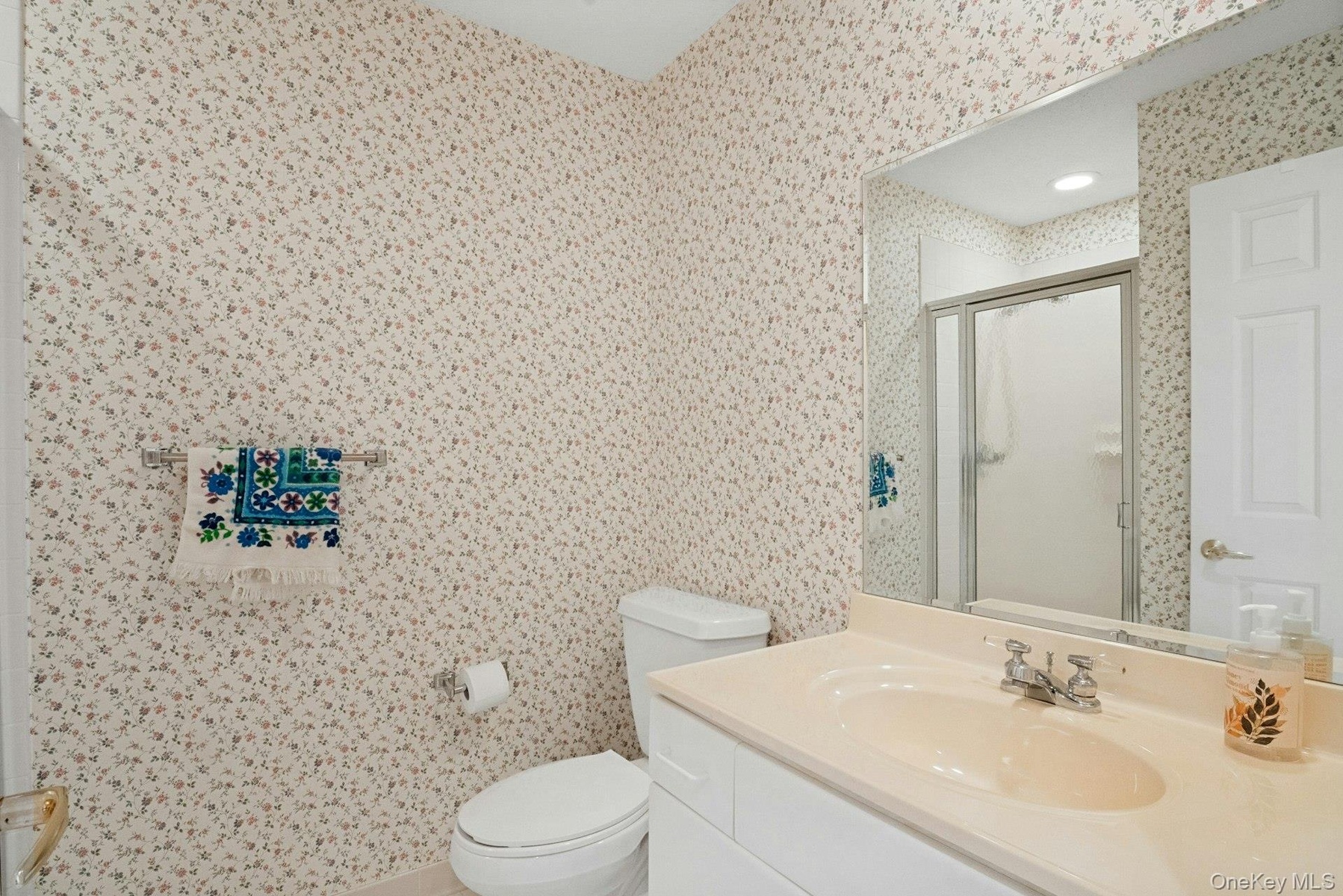 Guest bathroom with  shower in the hall adjacent to the second bedroom