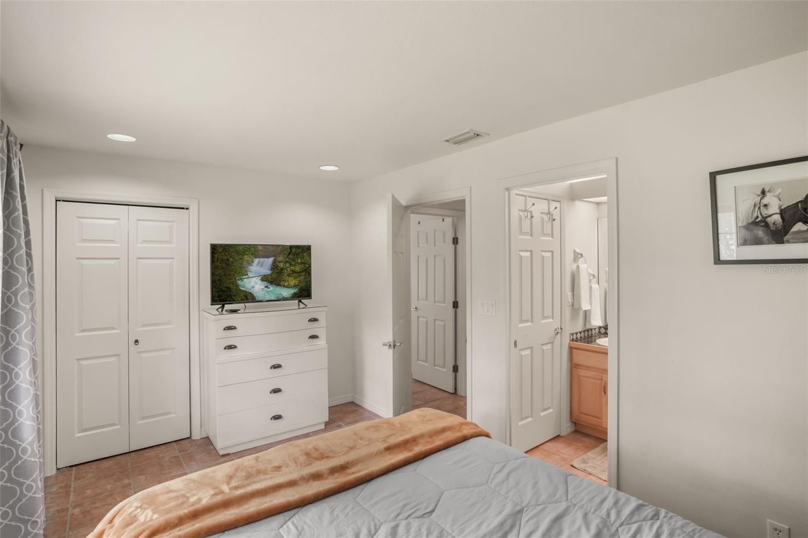 Guest bedroom featuring a spacious closet and convenient access to the guest bathroom