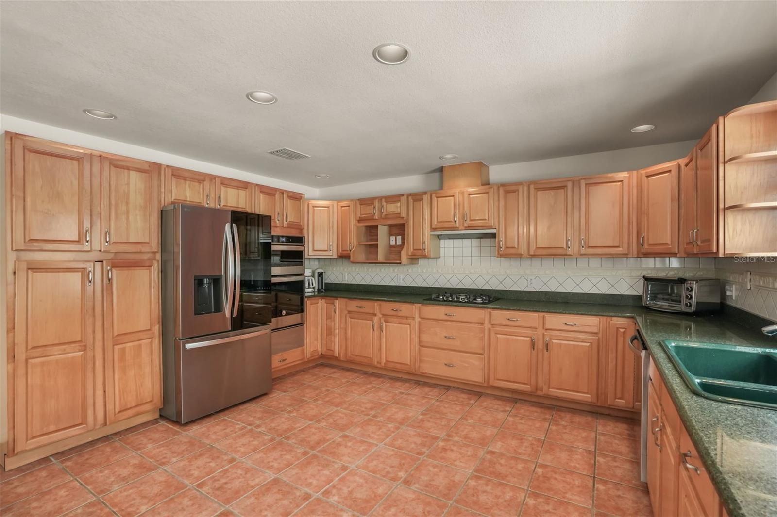 Spacious kitchen featuring solid wood cabinetry and generous countertop space